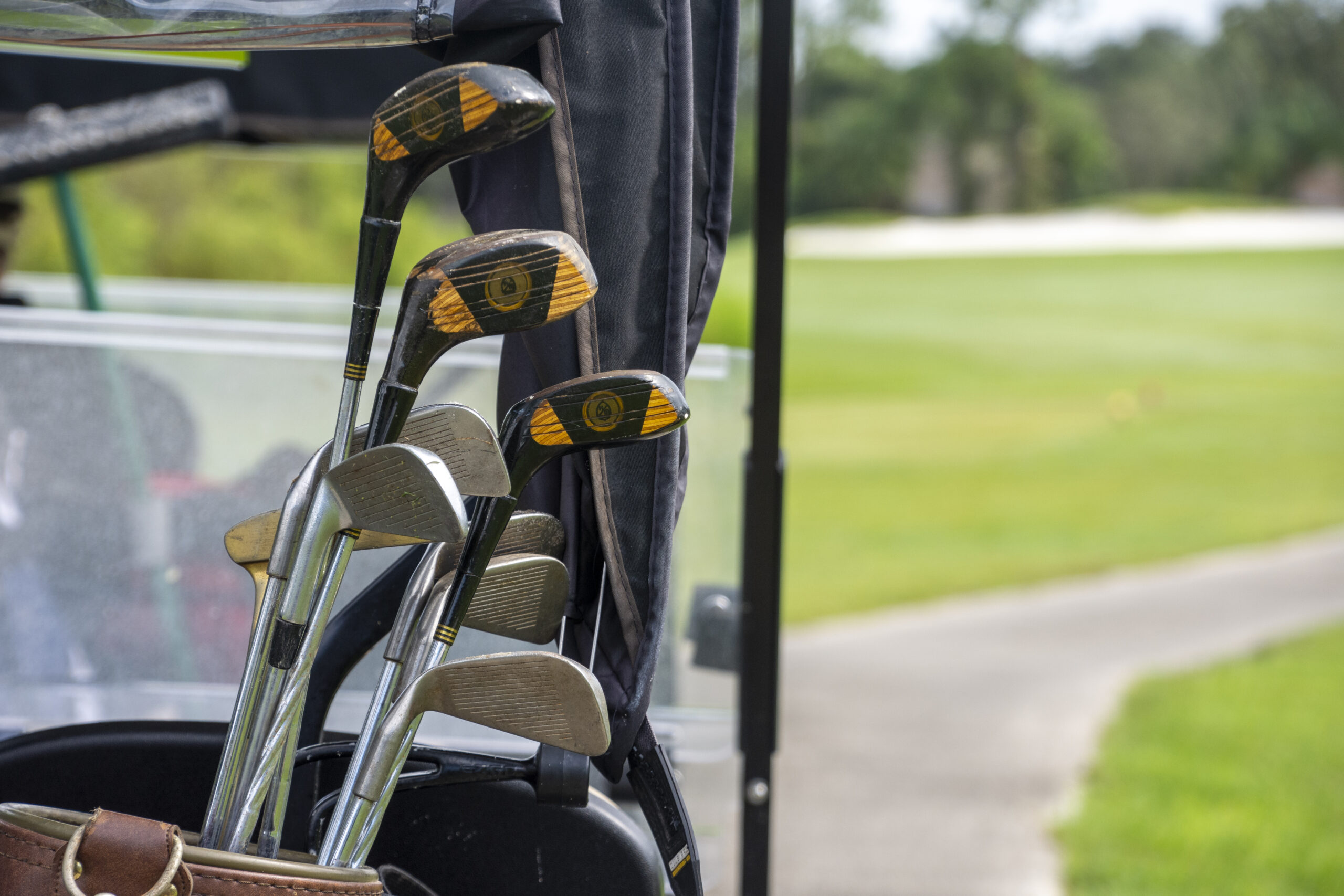 A set of golf clubs sticking out of a golf bag