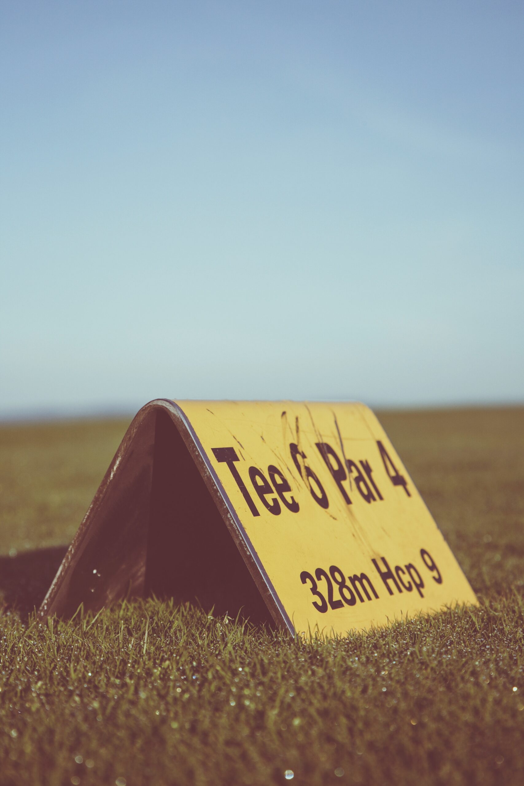 A golf tee displaying tee number five, par 4 and handicap.