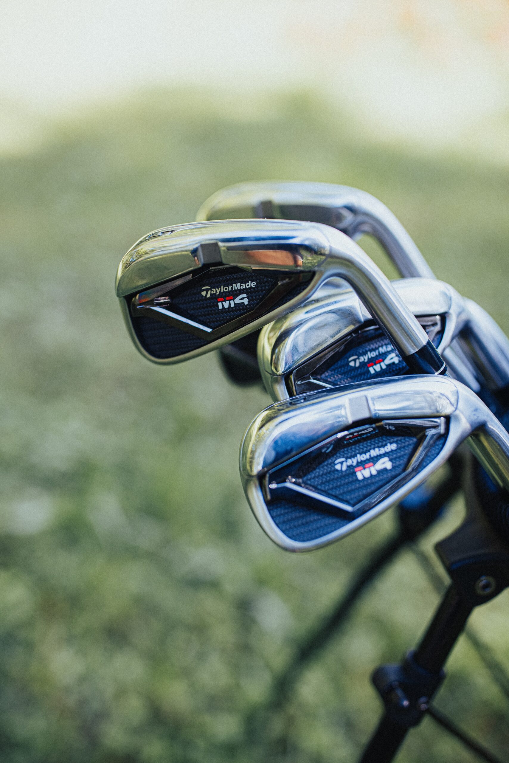 Close up image of a brand new set of Taylor Made golf clubs.