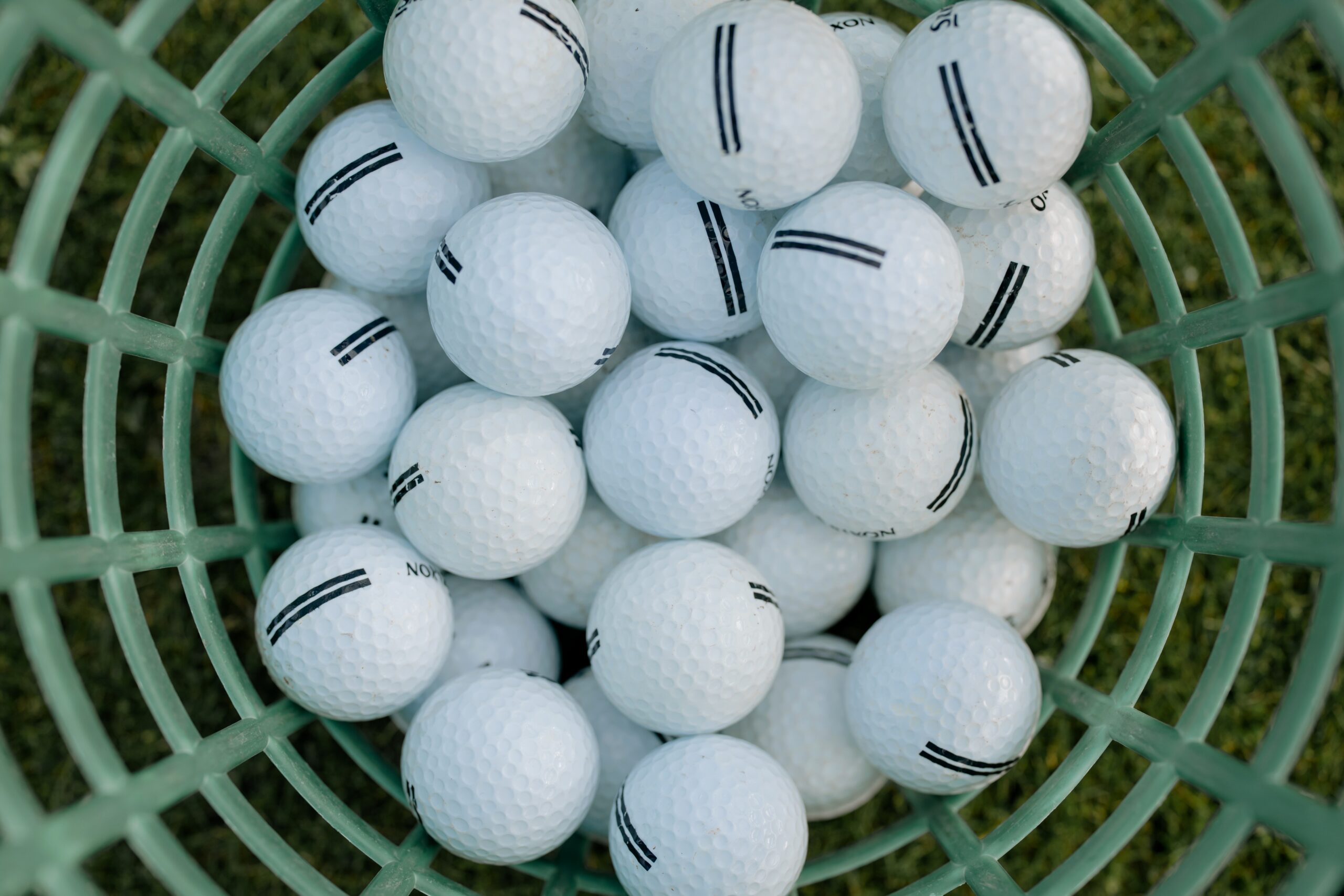 An aerial view of a bucket of clean golf balls.