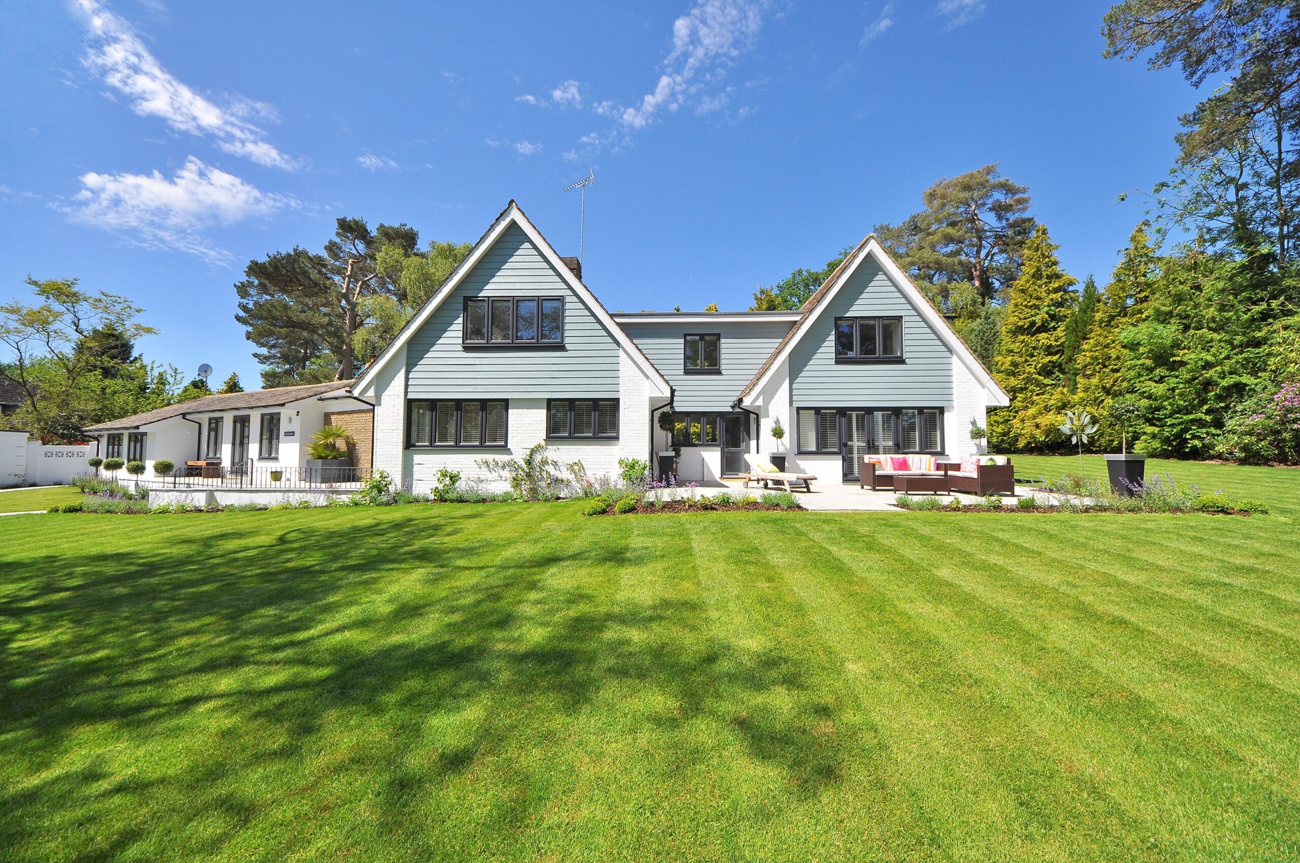 A modern home with a manicured lawn out front.