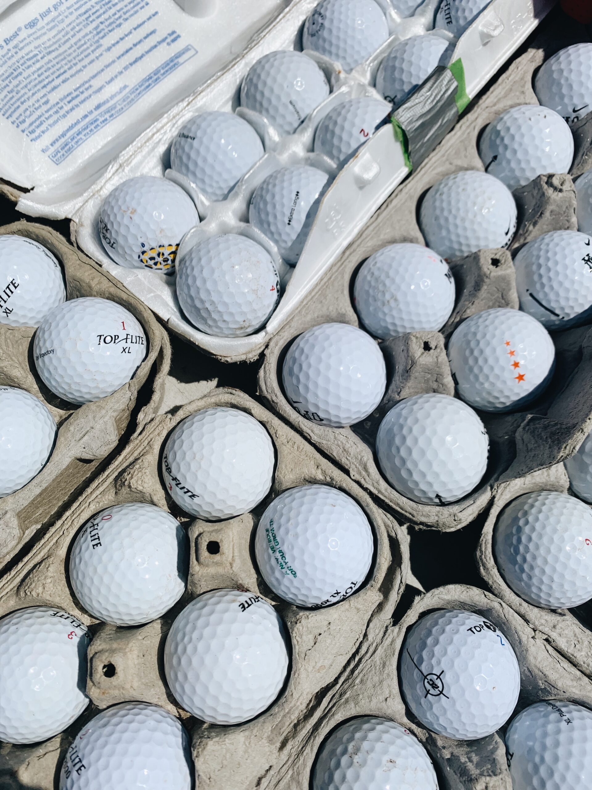 Golf balls in egg cartons.