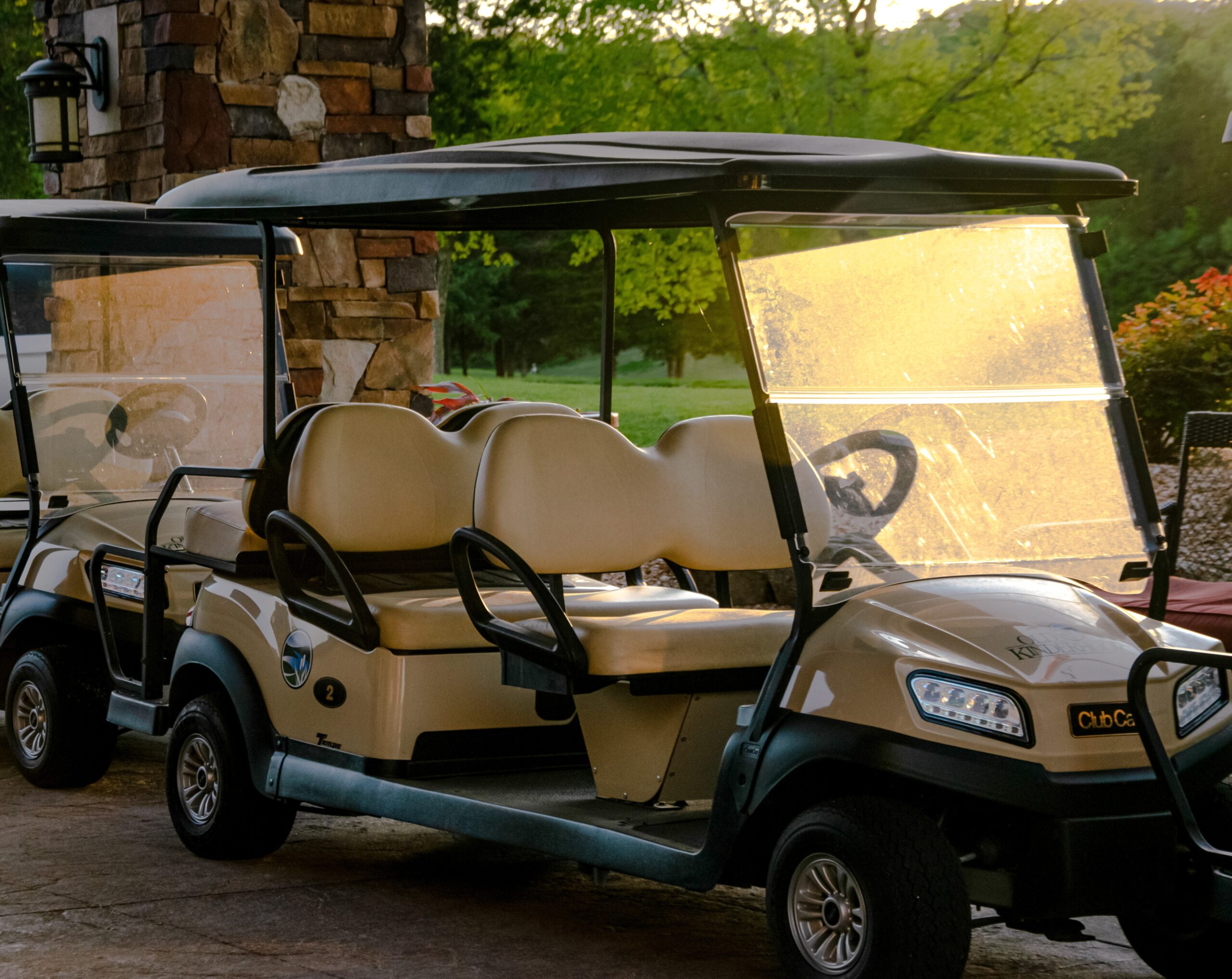 A six-seater golf cart in golden hour.